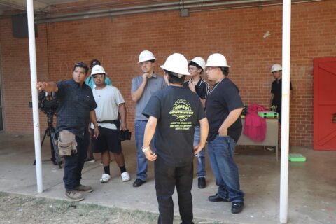 Haunted Courtyard at Arlington High School under construction. Teacher Christopher Grimaldo directs students.